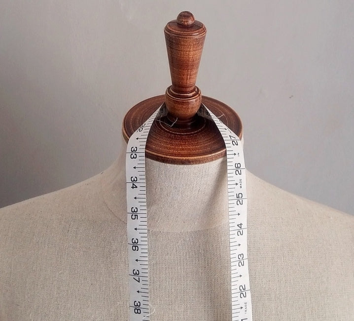Tape Measure hung around the neck of a makers mannequin