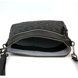 Interior of the Yasmin Women's Black Leather Cross Body Bag with weave detailing and striped interior