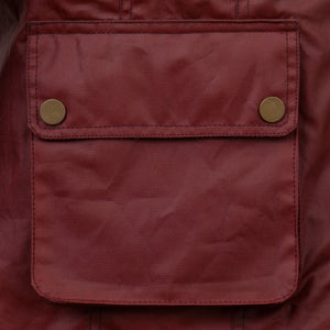 Close up of the poppered pockets of the Harriet Red Wax Coat