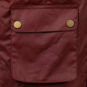 Close up of the poppered pockets of the Cora Red Wax Gilet